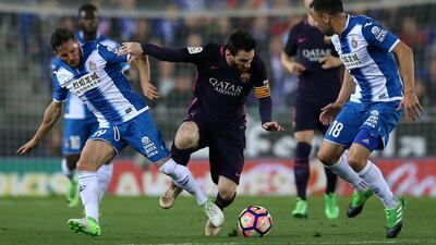 Barcelona’s Lionel Messi and Espanyol’s Pablo Piatti and Javi Fuego in action. Albert Gea / Reuters