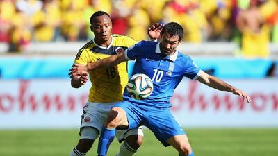 Juan Camilo Zuniga, left, of Colombia and Giorgos Karagounis of Greece battle for the ball during their 2014 Fifa World Cup Group C match at Estadio Mineirao on June 14, 2014, in Belo Horizonte, Brazil. Ian Walton / Getty Images