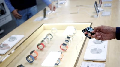 A shopper holds an Apple Watch at a store in Mexico. Reuters