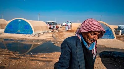 An elderly Syrian man, displaced from Ras al-Ain, walks in front of tents in the camp at Washokani in the northeastern Syrian al-Hasakeh governorate. AFP