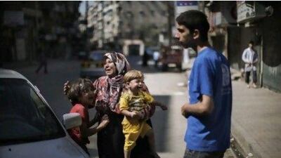 As an attempt by an Islamic quartet to negotiate peace in Syria began with Saudi Arabia failing to show up, Syrians, like this distraught family outside an Aleppo hospital, continue to suffer.