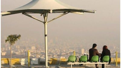 Iranians spend their time in the Tochal area, northern Tehran, as rooftops are seen in background, shrouded in polluted air. Heavy air pollution has forced Iranian authorities to close government offices and declare a two-day public holiday in the capital.
