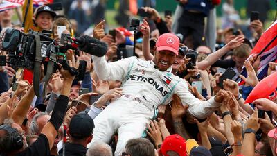 Lewis Hamilton celebrated with fans by going crowd surfing after winning the British Grand Prix. EPA