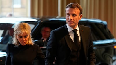 French President Emmanuel Macron and his wife Brigitte arrive for the reception hosted by King Charles. AP