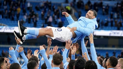 Manchester City players throw Sergio Aguero in the air to celebrate winning the Premier League title and his imminent exit from the club in May, 2021. AP