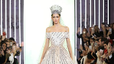 Off-white bridal gown asymmetrically hand-embellished with laser-cut mirrors, sequins and beads in ombré copper