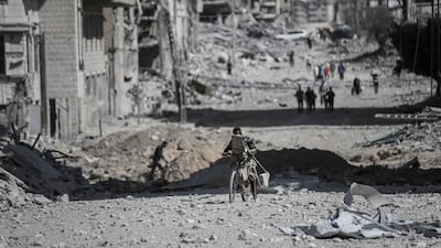 People pass along a road lined by destroyed buildings in Gaza city on Friday after the Israeli military withdrew as part of a ceasefire agreement. Bloomberg