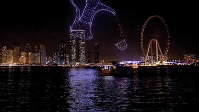 A light show in the shape of a dallah coffee pot pouring liquid into a cup near Bluewaters Island in December last year. AFP