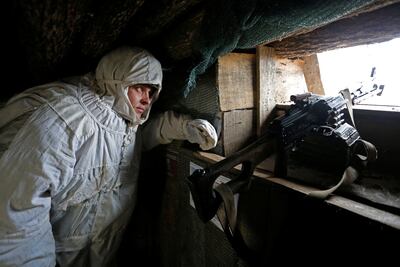 A militant of the self-proclaimed Donetsk People's Republic (DNR) observes the area at fighting positions on the line of separation from the Ukrainian armed forces near the rebel-controlled settlement of Yasne (Yasnoye) in Donetsk region, Ukraine January 14, 2022. REUTERS / Alexander Ermochenko