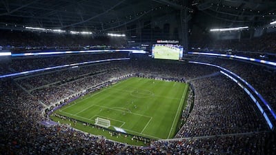 Fans watch as AC Milan play Chelsea in an exhibition match. Bruce Kluckhohn / AP Photo