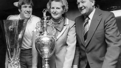 Margaret Thatcher poses with Liverpool's Emlyn Hughes and coach Bob Paisley.