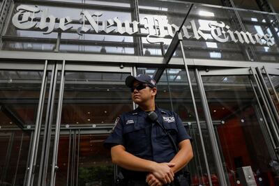 A New York Police officer is seen deployed outside the New York Times building following a fatal shooting at a Maryland newspaper. REUTERS/Brendan McDermid