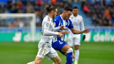 Alaves' Spanish forward Lucas Perez (R) vies with Real Madrid's Welsh forward Gareth Bale. AFP