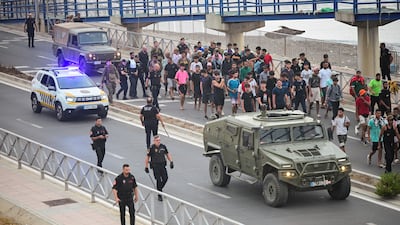 Migrants are led to the border between Spanish territory and Morocco. Reuters