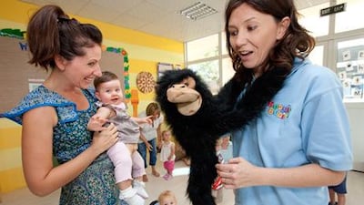 Amanda Ebersohn, above right, leads a Boogie Babies activity for Mumcierge in Dubai. And below, a whole group plays along.