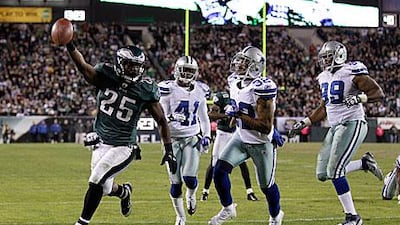 LeSean McCoy, left, celebrates as he runs in a touchdown for the Philadelphia Eagles to help defeat the Dallas Cowboys 34-7.