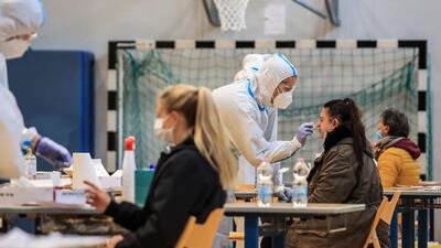 Residents undergo a free rapid swab test for Covid-19 at a testing facility set up in a school sports hall, in Bolzano, South Tyrol, Northern Italy. AFP