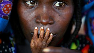 The fingers of malnourished one-year-old Alassa Galisou are pressed against the lips of his mother Fatou Ousseini at an emergency feeding clinic in the town of Tahoua in northwestern Niger, on August 1, 2005. Finbarr O’Reilly / Reuters