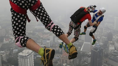 BASE jumpers are pictured against the skyline shrouded in a thick haze during the Kuala Lumpur Tower International Jump in Kuala Lumpur, Malaysia. More than 100 BASE jumpers take part in this extreme sport event, which enters its 15th year. The haze hovering over Malaysia is caused by the ongoing plantation and forest fires in the nearby Indonesian provinces of Sumatra and Kalimantan. Fazry Ismail / EPA