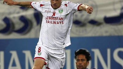 UAE's Al-Nasr club player Luis Jimenez (r) tries to tackle as Uzbekistan's Lokomotiv club player Server Djeparov during their Asian Champions League (AFC) group A football match at the Rashid Al-Maktoum Stadium in Dubai on April 20, 2016. / AFP / KARIM SAHIB