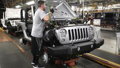 A worker assembles the 2014 Jeep Wrangler. Bill Pugliano / Getty Images / AFP