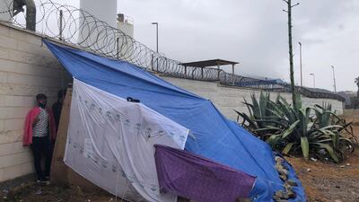 Migrants sleep on cardboard boxes and under a makeshift tent near Benitez beach, Ceuta. Karen Rice
