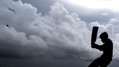 A youth plays cricket on the Galle Face Green in Colombo. AFP