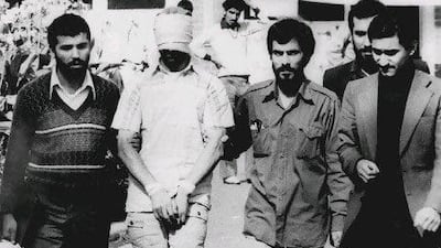 An American hostage held at the US Embassy in Tehran is shown blindfolded and with his hands bound in November 9, 1979. Fifty-two of the hostages endured 444 days of captivity.