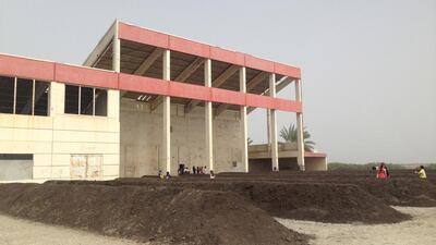The exterior facade of the abandoned ice factory in Kalba. The site of Adrian Villar Rojas installation at Sharjah Biennial 12. Image by Anna Seaman