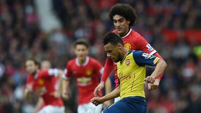 Arsenal's Francis Coquelin challenges Mrouane Fellaini during their Premier League contest on Sunday. Paul Ellis / AFP / May 17, 2015