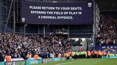 Stewards and police clash with fans as play is stopped due to crowd trouble. Reuters