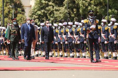 Sudan's Chairman of the Transitional Sovereignty Council, Lt Gen Abdel Fattah Al Burhan walks with Egyptian President Abdel Fatah El Sisi during a welcome ceremony in Khartoum. Sudan Sovereign Council Handout