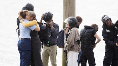 Family disembark from a speedboat after being on the HMNZS Wellington where they observed a minutes silence near White Island in Whakatane, New Zealand. Getty Images