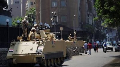 Soldiers guard the streets in Cairo yesterday after the army removed Mohammed Morsi as president last week. Hiro Komae / AP Photo