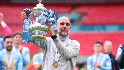 Manchester City manager Pep Guardiola celebrates with the trophy after winning the FA Cup final match against Chelsea on May 16, 2026, in London, England. It was the third time City had won the competition under Guardiola. Getty Images