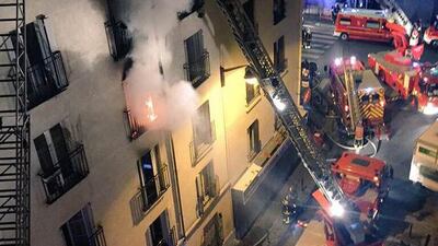 Firefighters battle the flames of a fire at an apartment building in the north of Paris. Norman Grandjean / AFP Photo