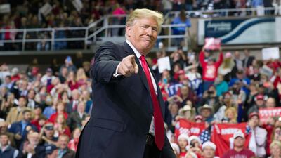 President Donald Trump points to a supporter as he departs a rally at the Mississippi Coast Coliseum in Biloxi. AP/Alex