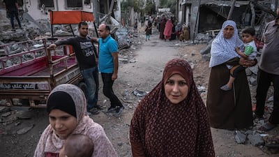 Palestinians walk around Beit Hanoun, northern Gaza, on May 22, 2021. Getty