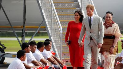 Britain's Prince Harry and Meghan, Duchess of Sussex, flanked by Tonga's Princess Angelika Latufuipeka, arrive at Fua'amotu airport on the main island Tongatapu in Tonga. Reuters