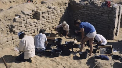 Archaeologists uncover artefacts at a burial site.