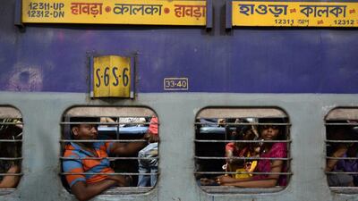 Passengers travel in a non-air conditioner sleeper coach on-board the train.