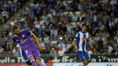 Real Madrid’s Karim Benzema, left, kicks the ball to scores during the Spanish Primera Liga match against Espanyol. Manu Fernandez / AP Photo
