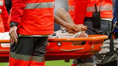 Real Madrid defender Eder Militao is carried off the pitch after sustaining a knee injury. EPA