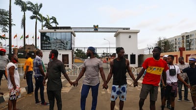Demonstrators hold hands as they gather near the Lagos State House, despite a round-the-clock curfew imposed by the authorities on the Nigerian state of Lagos in response to protests against alleged police brutality, Nigeria October 20, 2020. REUTERS