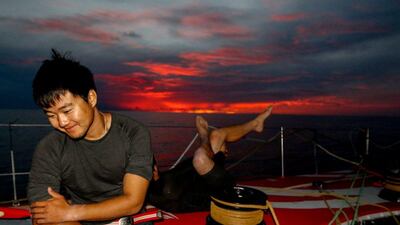 Jiru Yang of Donfgeng Race Team, and behind him Kevin Escoffier, take in a moment of ease as the boat drifts through the gust-less doldrums of the Atlantic. Yann Riou / Dongfeng Race Team / Volvo Ocean Race / October 21, 2014