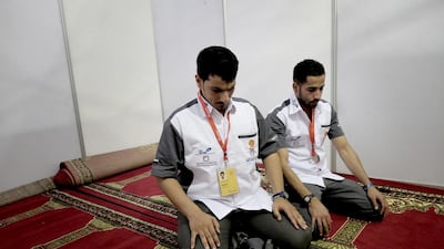 Saif Alhajar and Ibrahim Almadabi of the UAE take a break for morning prayers during the Shell Eco-marathon in Manila. Jes Aznar for The National