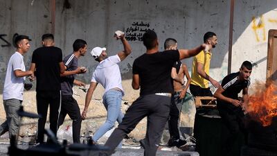 Protesters hurl rocks at Israeli security forces' vehicles. AFP