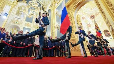 Soldiers carry the Russian national flag and the Standard of the President of the Russian Federation into the Kremlin's ornately decorated Andreyevsky Hall. AFP