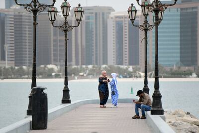 Women spend time by the Corniche, Abu Dhabi. Khushnum Bhandari / The National