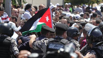Jordanian teachers confront security forces in the capital Amman on the first day of their strike on September 5, 2019. AFP